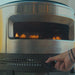 hand turning up the heat on a solo stove pi prime pizza oven